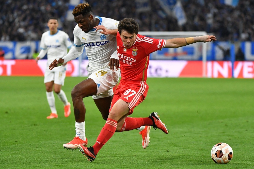 Marseille's Faris Moumbagna fights for the ball with Benfica's Joao Neves during the UEFA Europa League quarter final second leg football match between Olympique de Marseille (OM) and SL Benfica at the Stade Velodrome in Marseille on April 18, 2024. (Photo by SYLVAIN THOMAS/AFP via Getty Images)