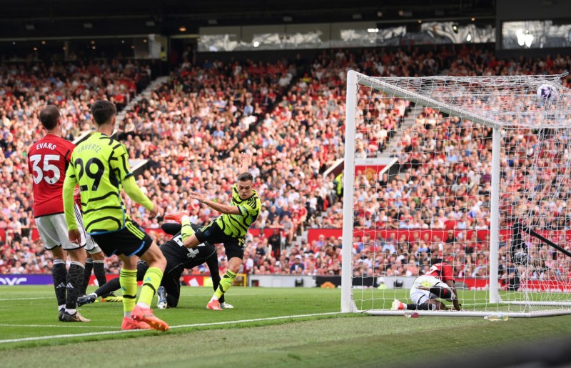 MANCHESTER, ENGLAND - MAY 12: Leandro Trossard of Arsenal scores his team's first goal during the Premier League match between Manchester United and Arsenal FC at Old Trafford on May 12, 2024 in Manchester, England. (Photo by Stu Forster/Getty Images)