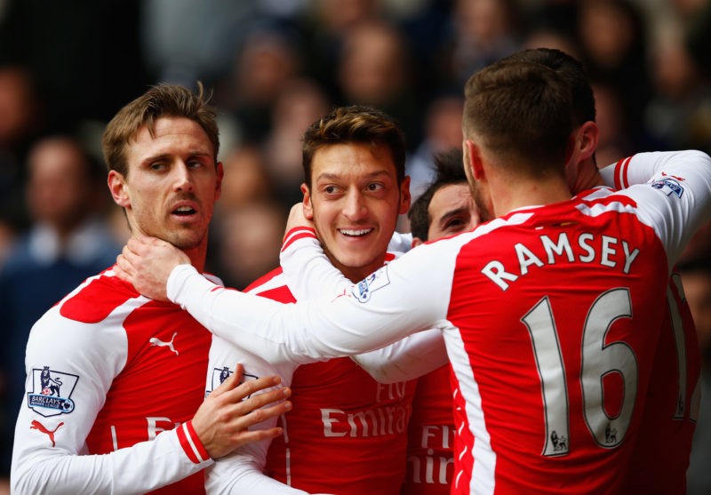 LONDON, ENGLAND - FEBRUARY 07: Mesut Oezil of Arsenal celebrates scoring the opening goal with team mates during the Barclays Premier League match between Tottenham Hotspur and Arsenal at White Hart Lane on February 7, 2015 in London, England. (Photo by Clive Rose/Getty Images)