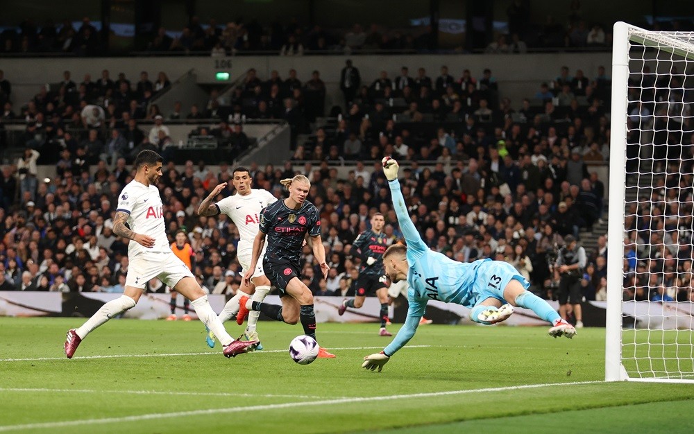 LONDON, ENGLAND: Guglielmo Vicario of Tottenham Hotspur fails to save a cross from Kevin De Bruyne of Manchester City (not pictured) before Erling Haaland of Manchester City scores his team's first goal during the Premier League match between Tottenham Hotspur and Manchester City at Tottenham Hotspur Stadium on May 14, 2024. (Photo by Julian Finney/Getty Images)