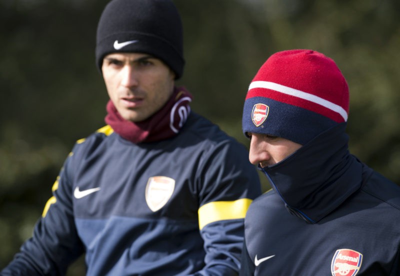 Arsenal's Spanish midfielder Mikel Arteta (L) and Arsenal's Spanish midfielder Santi Cazorla (R) walk to the pitch for a training session at the club's complex in London Colney on March 12, 2013 ahead of the team's last 16 UEFA Champions League football match against Bayern Munich in Germany on March 13.(Photo credit ADRIAN DENNIS/AFP via Getty Images)