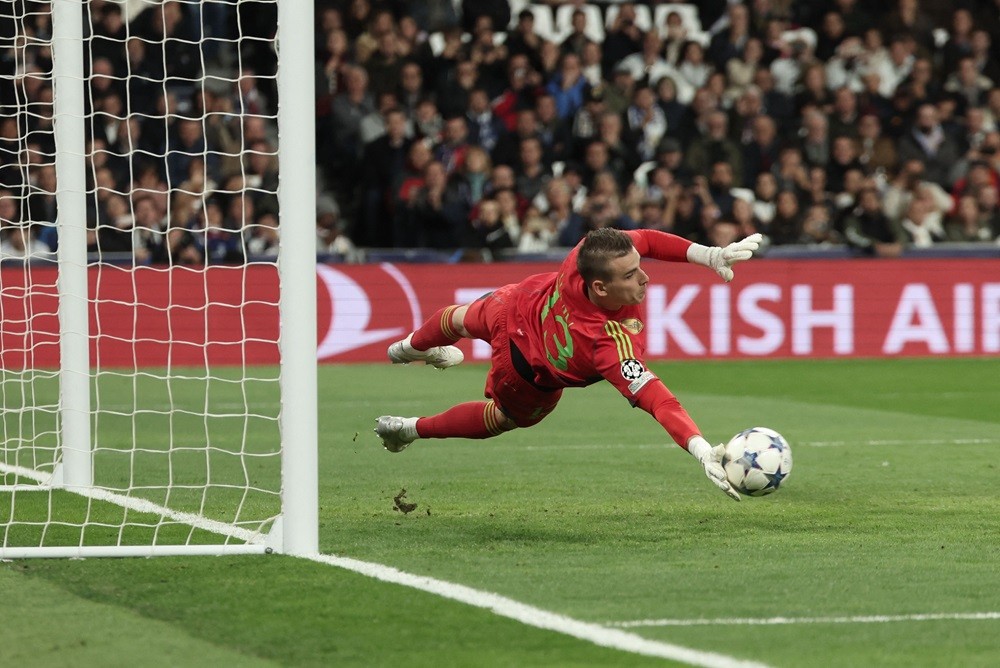 Real Madrid's Andriy Lunin stops the ball during the UEFA Champions League group C football match between Real Madrid CF and SC Braga at the Santiago Bernabeu stadium in Madrid on November 8, 2023. (Photo by THOMAS COEX/AFP via Getty Images)