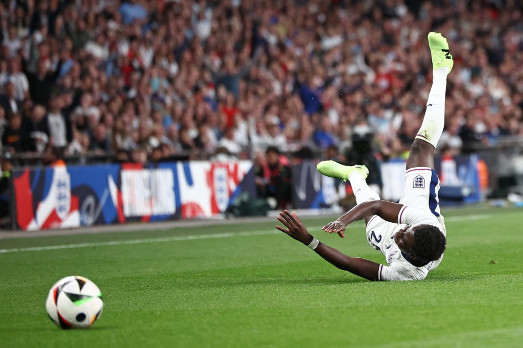England's midfielder #25 Bukayo Saka is fouled during the International friendly football match between England and Iceland at Wembley Stadium in London on June 7, 2024. (Photo by HENRY NICHOLLS/AFP via Getty Images)