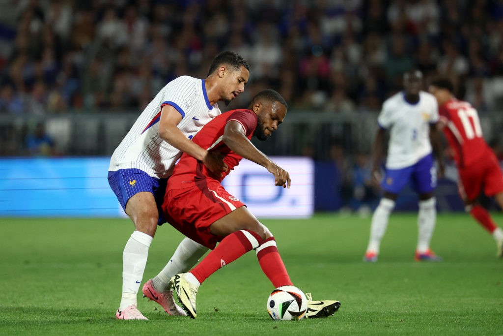 France's defender #17 William Saliba (L) and Canada's forward #09 Cyle Larin (R) fight for the ball during the International friendly football match between France and Canada at the Matmut Atlantique stadium in Bordeaux, on June 9, 2024. (Photo by FRANCK FIFE/AFP via Getty Images)