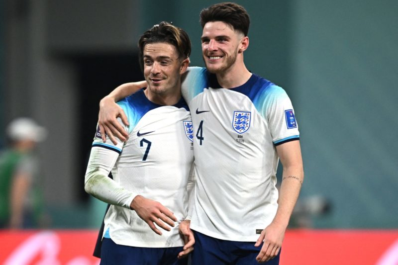 England's forward #07 Jack Grealish (L) and midfielder #04 Declan Rice celebrate their win at the end of the Qatar 2022 World Cup Group B football match between England and Iran at the Khalifa International Stadium in Doha on November 21, 2022. (Photo by PAUL ELLIS/AFP via Getty Images)