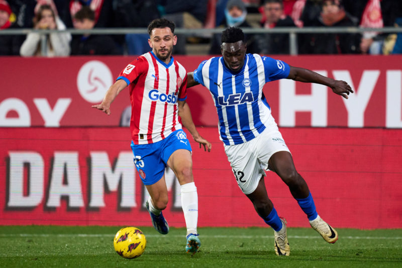 GIRONA, SPAIN - DECEMBER 18: Ivan Martin of Girona FC battles for possession with Samu Omorodion of Deportivo Alaves during the LaLiga EA Sports match between Girona FC and Deportivo Alaves at Montilivi Stadium on December 18, 2023 in Girona, Spain. (Photo by Alex Caparros/Getty Images)