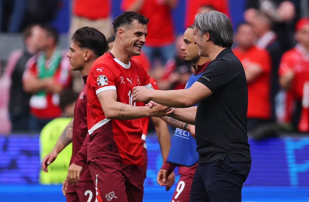 COLOGNE, GERMANY: Granit Xhaka of Switzerland and Murat Yakin, Head Coach of Switzerland, celebrate after the team's victory in the UEFA EURO 2024 group stage match between Hungary and Switzerland at Cologne Stadium on June 15, 2024. (Photo by Alex Grimm/Getty Images)
