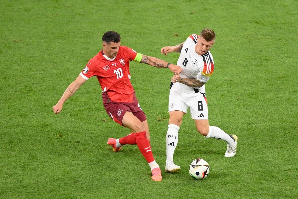 FRANKFURT AM MAIN, GERMANY: Granit Xhaka of Switzerland is challenged by Toni Kroos of Germany during the UEFA EURO 2024 group stage match between Switzerland and Germany at Frankfurt Arena on June 23, 2024. (Photo by Justin Setterfield/Getty Images)