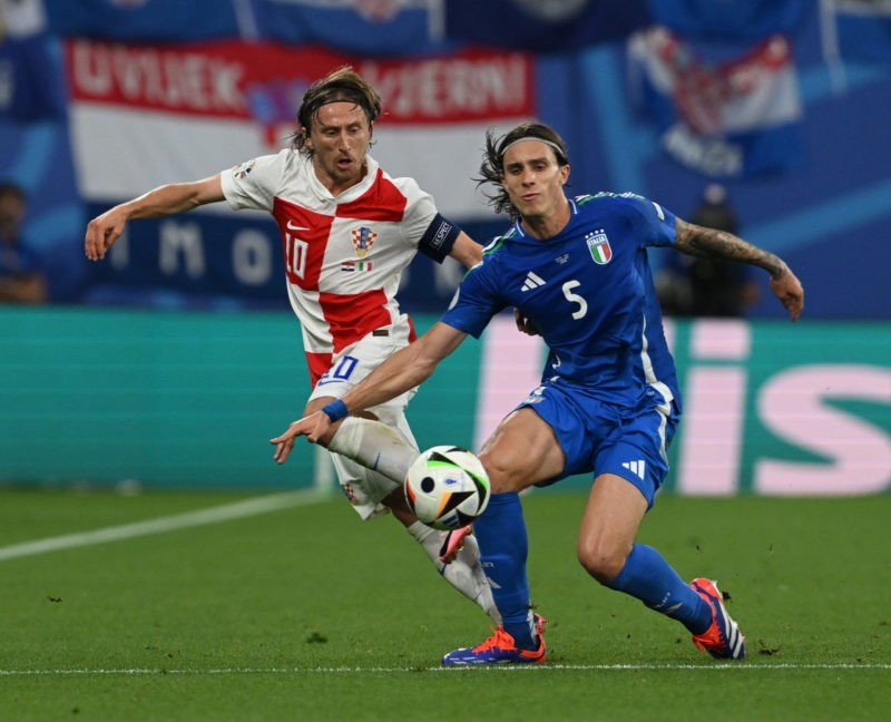 LEIPZIG, GERMANY - JUNE 24: Luka Modric of Croatia and Riccardo Calafiori of Italy compete for the ball during the UEFA EURO 2024 group stage match between Croatia and Italy at Football Stadium Leipzig on June 24, 2024 in Leipzig, Germany. (Photo by Claudio Villa/Getty Images for FIGC)