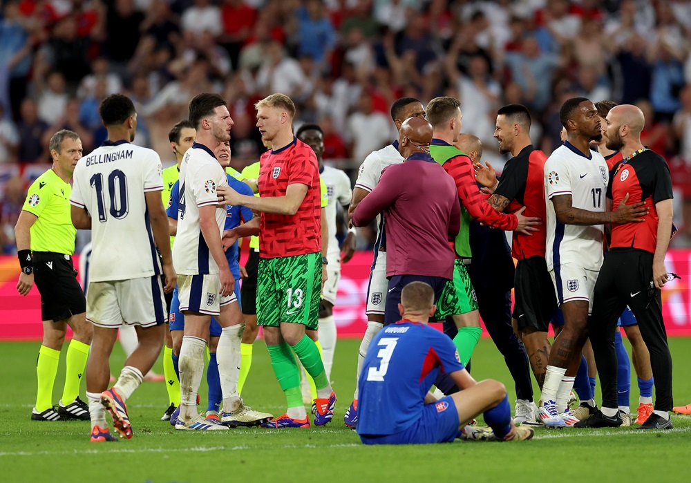 GELSENKIRCHEN, GERMANY: Declan Rice of England clashes with a member of staff from Slovakia afterg the UEFA EURO 2024 round of 16 match between England and Slovakia at Arena AufSchalke on June 30, 2024. (Photo by Richard Pelham/Getty Images)