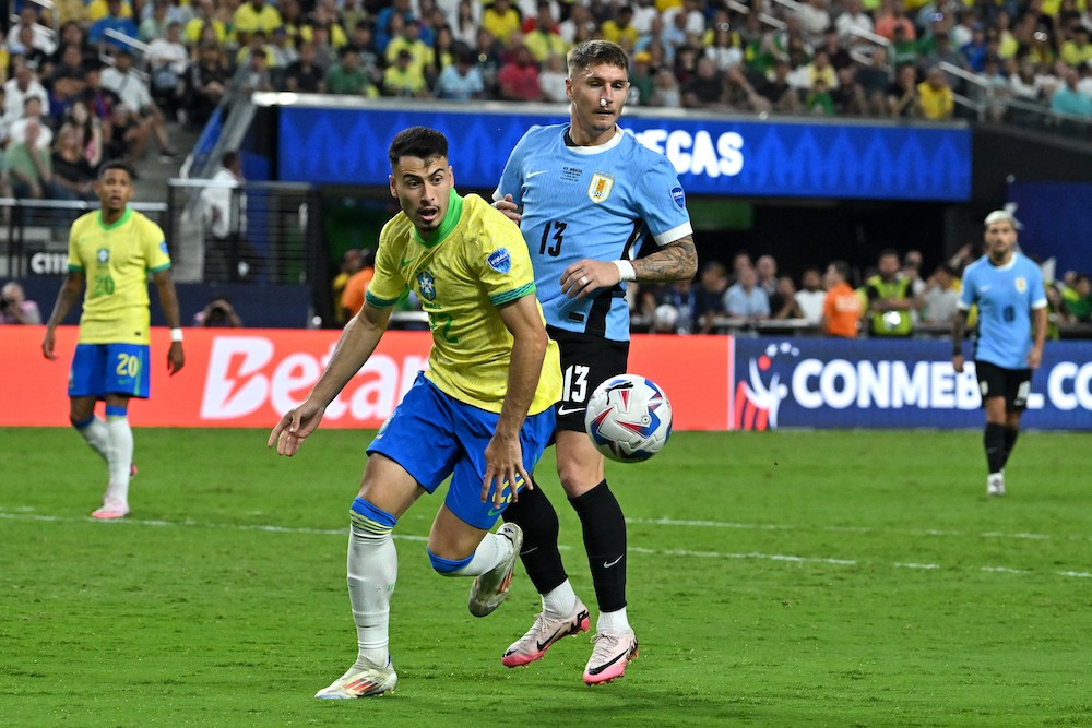 Brazil's Gabriel Martinelli fights for the ball with Uruguay's Guillermo Varela during the Conmebol 2024 Copa America tournament quarter-final football match between Uruguay and Brazil at Allegiant Stadium in Las Vegas, Nevada on July 6, 2024. (Photo by Robyn Beck / AFP)