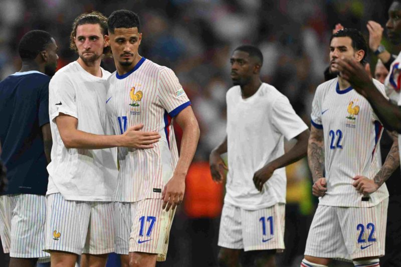 France's midfielder #14 Adrien Rabiot consoles France's defender #17 William Saliba after the UEFA Euro 2024 semi-final football match between Spain and France at the Munich Football Arena in Munich on July 9, 2024. (Photo by FABRICE COFFRINI/AFP via Getty Images)