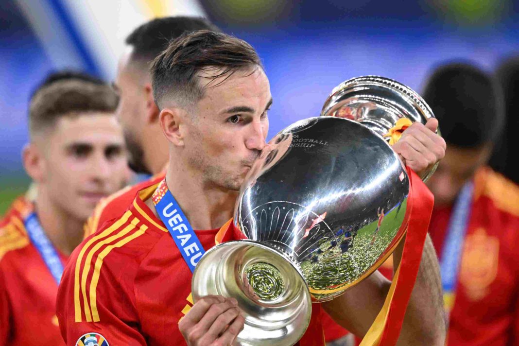 Spain's midfielder #08 Fabian Ruiz celebrates with the trophy after winning the UEFA Euro 2024 final football match between Spain and England at the Olympiastadion in Berlin on July 14, 2024. (Photo by Kirill KUDRYAVTSEV / AFP) (Photo by KIRILL KUDRYAVTSEV/AFP via Getty Images)