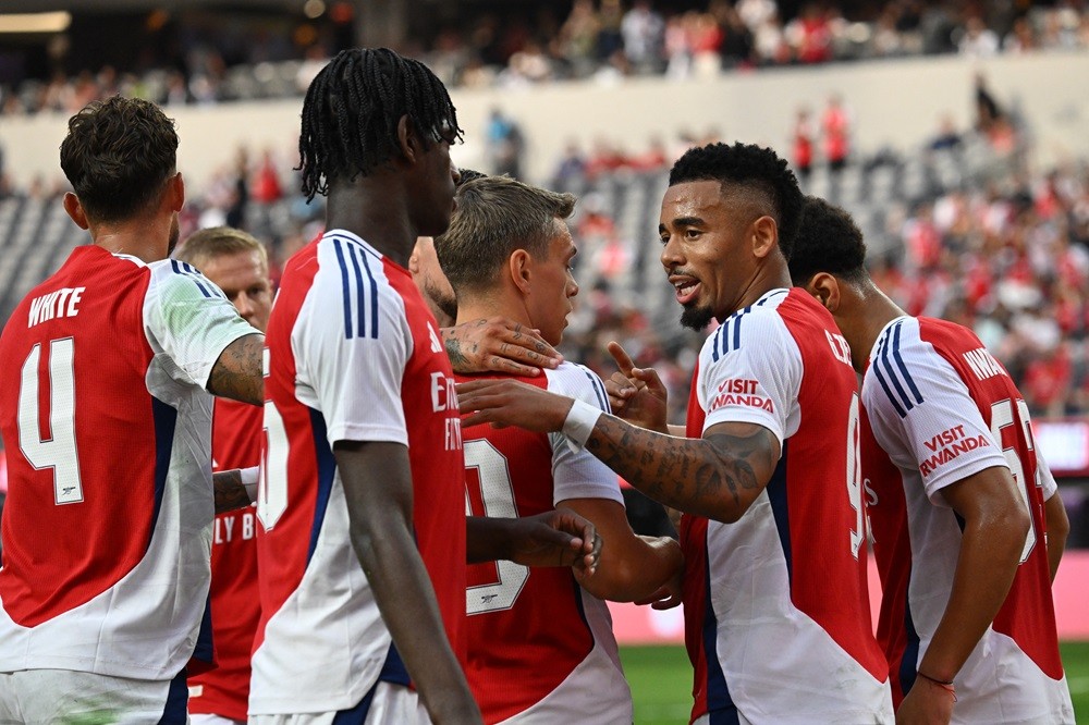 Arsenal's Gabriel Jesus (R) celebrates with teammates after scoring a goal during the pre-season club friendly football match between Manchester United FC and Arsenal FC at SoFi Stadium in Inglewood, California on July 27, 2024. (Photo by PATRICK T. FALLON/AFP via Getty Images)