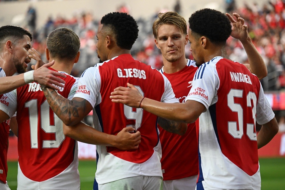 Arsenal's Gabriel Jesus (C) celebrates with Martin Odegaard (2nd R) and teammates after scoring a goal during the pre-season club friendly football match between Manchester United FC and Arsenal FC at SoFi Stadium in Inglewood, California on July 27, 2024. (Photo by PATRICK T. FALLON/AFP via Getty Images)