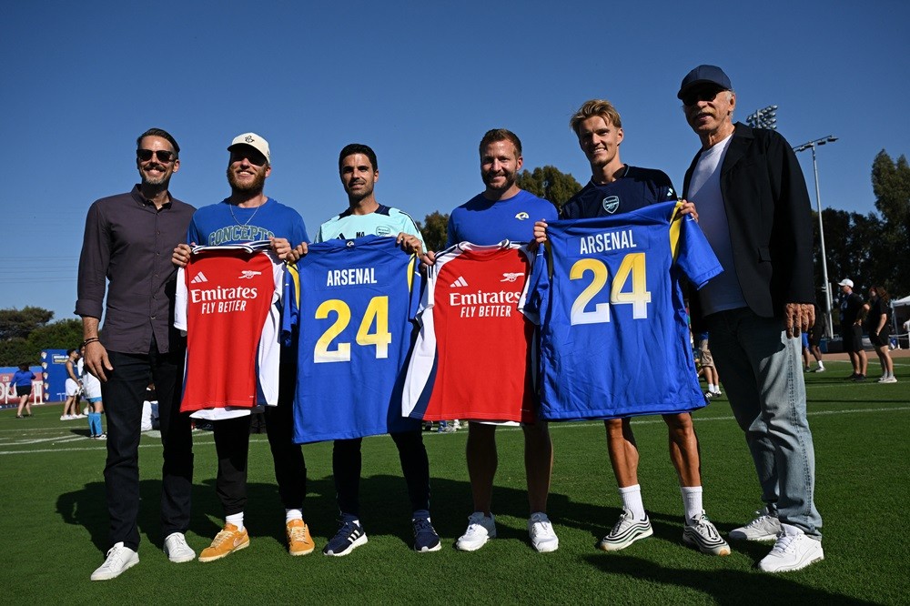 (L-R) Josh Kroenke, Cooper Kupp, Mikel Arteta, Sean McVay, Martin Ødegaard, and Stan Kroenke during the "Football Meets Football" Youth Clinic at the LA Rams NFL training camp on the Loyola Marymount University (LMU) campus on July 26, 2024. (Photo by PATRICK T. FALLON/AFP via Getty Images)