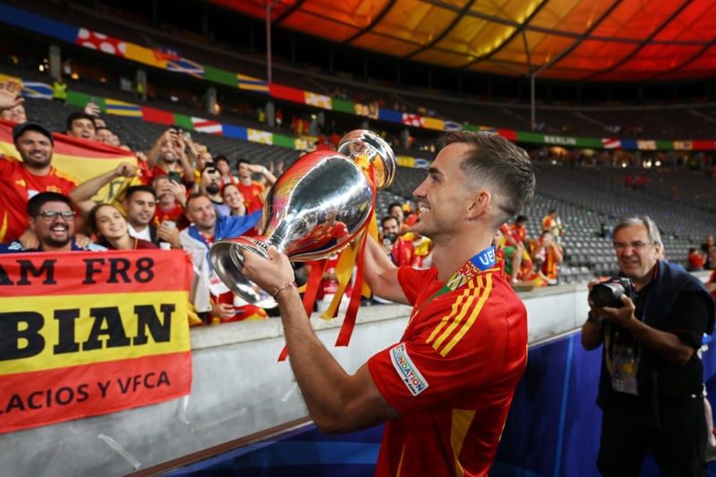 BERLIN, GERMANY - JULY 14: Fabian Ruiz of Spain celebrates with the fans with the UEFA Euro 2024 Henri Delaunay Trophy after his team's victory in the UEFA EURO 2024 final match between Spain and England at Olympiastadion on July 14, 2024 in Berlin, Germany. (Photo by Dan Mullan/Getty Images)