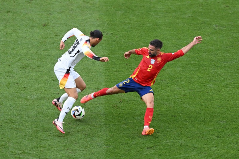 STUTTGART, GERMANY - JULY 05: Leroy Sane of Germany is challenged by Daniel Carvajal of Spain during the UEFA EURO 2024 quarter-final match between Spain and Germany at Stuttgart Arena on July 05, 2024 in Stuttgart, Germany. (Photo by Clive Mason/Getty Images)