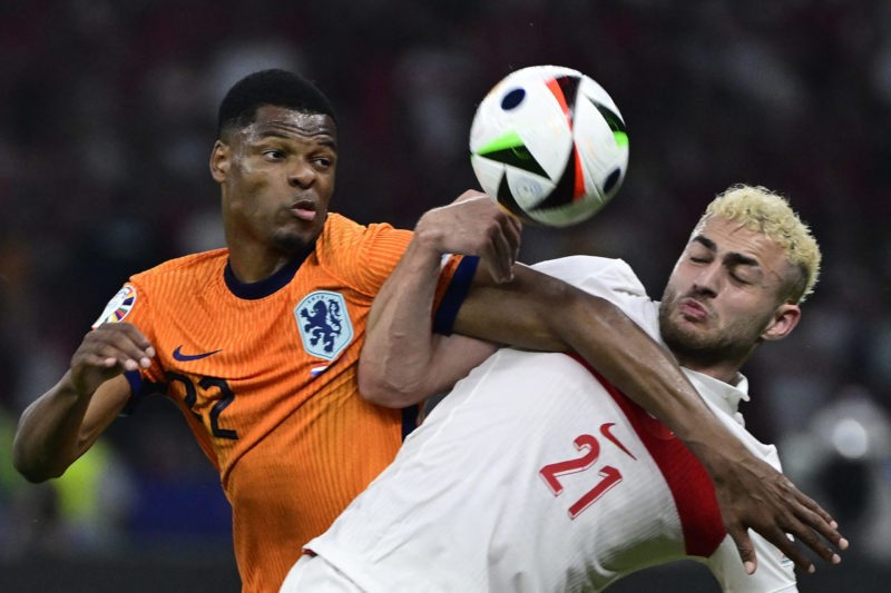 TOPSHOT - Turkey's forward #21 Baris Alper Yilmaz and Netherlands' defender #22 Denzel Dumfries fight for the ball during the UEFA Euro 2024 quarter-final football match between the Netherlands and Turkey at the Olympiastadion in Berlin on July 6, 2024. (Photo by JOHN MACDOUGALL/AFP via Getty Images)