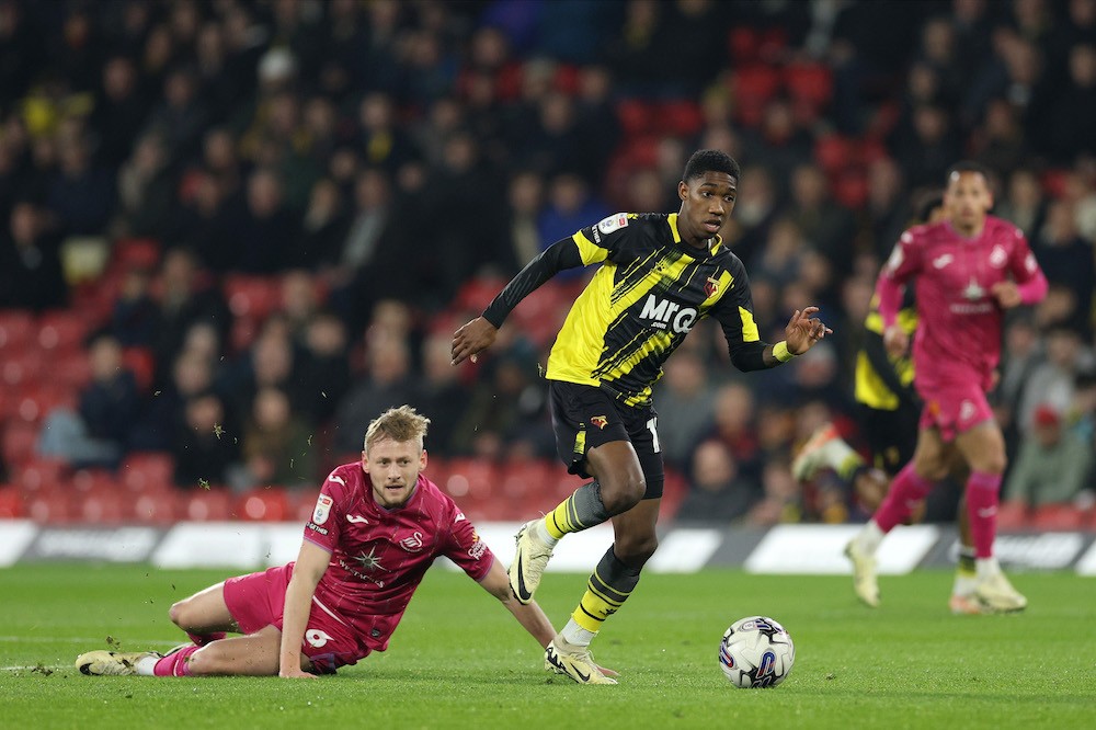 WATFORD, ENGLAND: Yaser Asprilla of Watford breaks with the ball from Harry Darling of Swansea City during the Sky Bet Championship match between Watford and Swansea City at Vicarage Road on March 06, 2024. (Photo by Richard Heathcote/Getty Images)