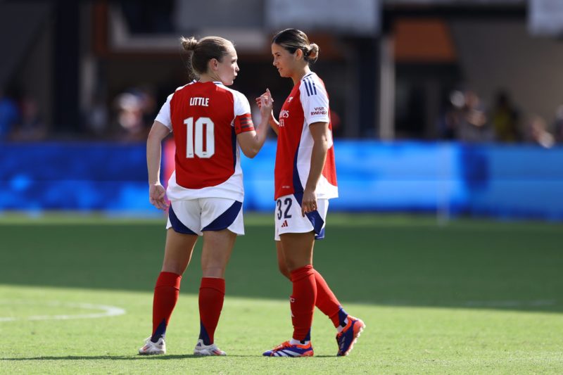 WASHINGTON, DC - AUGUST 25: Kim Little #10 and Kyra Cooney-Cross #32 of Arsenal speak before playing against Chelsea at Audi Field on August 25, 2024 in Washington, DC. (Photo by Tim Nwachukwu/Getty Images)