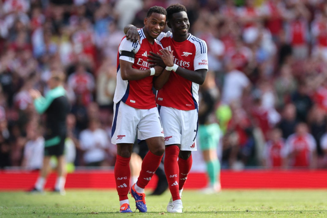 Arsenal's Dutch defender #12 Jurrien Timber (L) and Arsenal's English midfielder #07 Bukayo Saka (R) celebrate their win on the pitch after the English Premier League football match between Arsenal and Wolverhampton Wanderers at the Emirates Stadium in London on August 17, 2024. Arsenal won the game 2-0. (Photo by ADRIAN DENNIS/AFP via Getty Images)