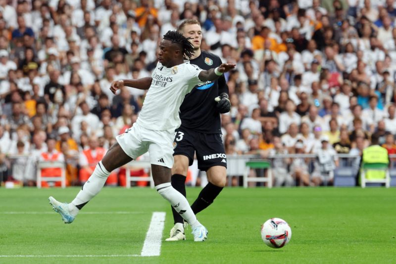 Real Madrid's Brazilian forward #07 Vinicius Junior (L) misses the ball next to Real Valladolid's Estonian goalkeeper #13 Karl Jakob Hein during the Spanish league football match between Real Madrid CF and Real Valladolid FC at the Santiago Bernabeu stadium in Madrid on August 25, 2024. (Photo by PIERRE-PHILIPPE MARCOU/AFP via Getty Images)