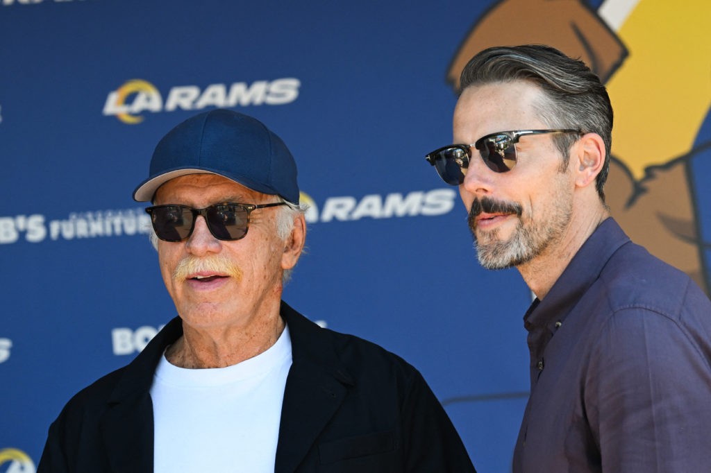 Los Angeles Rams' owner Stan Kroenke (L) chats with his son Josh Kroenke during the "Football Meets Football" Youth Clinic at the LA Rams NFL training camp on the Loyola Marymount University (LMU) campus on July 26, 2024 in Los Angeles, California. Arsenal FC will play Manchester United FC in an exhibition match at SoFi Stadium on Saturday as part of the Rivals in Red USA 2024 Tour. (Photo by Patrick T. Fallon / AFP) (Photo by PATRICK T. FALLON/AFP via Getty Images)