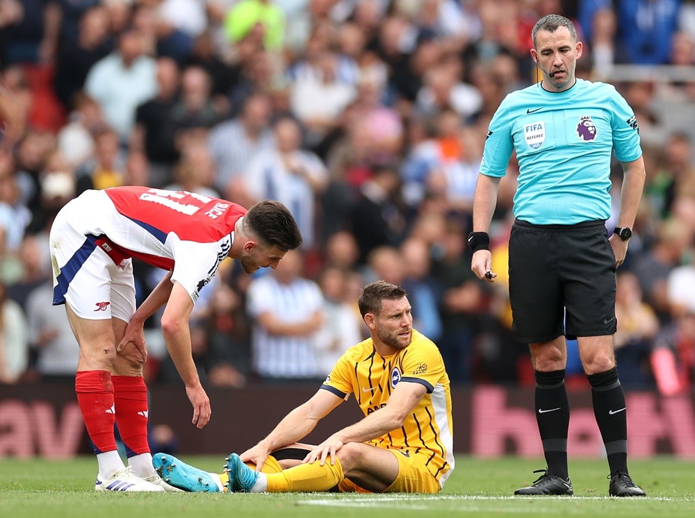 LONDON, ENGLAND: James Milner of Brighton & Hove Albion is consoled by Declan Rice of Arsenal following an injury during the Premier League match between Arsenal FC and Brighton & Hove Albion FC at Emirates Stadium on August 31, 2024. (Photo by Ryan Pierse/Getty Images)