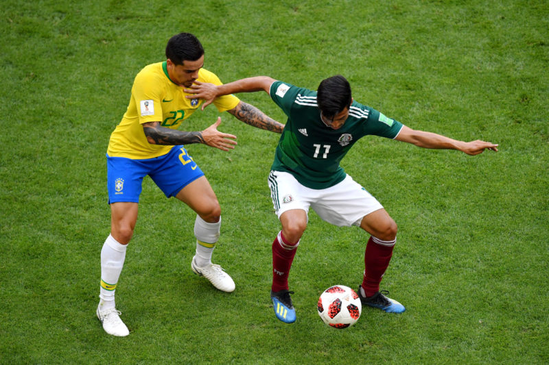 SAMARA, RUSSIA - JULY 02: Carlos Vela of Mexico is challenged by Fagner of Brazil during the 2018 FIFA World Cup Russia Round of 16 match between Brazil and Mexico at Samara Arena on July 2, 2018 in Samara, Russia. (Photo by Hector Vivas/Getty Images)