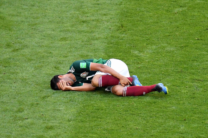 SAMARA, RUSSIA - JULY 02: Carlos Vela of Mexico lies on the pitch injured during the 2018 FIFA World Cup Russia Round of 16 match between Brazil and Mexico at Samara Arena on July 2, 2018 in Samara, Russia. (Photo by Hector Vivas/Getty Images)