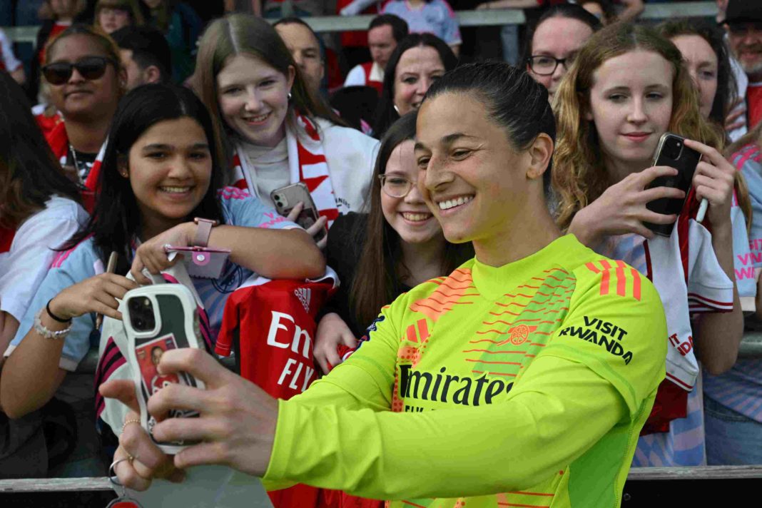 Arsenal's Canadian goalkeeper #14 Sabrina D'Angelo poses for selfie photographs with fans after the English Women's Super League football match between Arsenal and Brighton and Hove Albion at Meadow Park, in Borehamwood, on May 18, 2024.(Photo by GLYN KIRK/AFP via Getty Images)