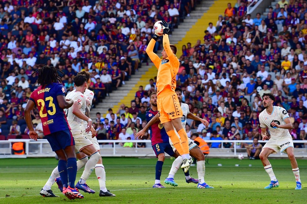 Real Valladolid's Karl Hein catches the ball during the Spanish league football match between FC Barcelona and Real Valladolid FC at the Estadi Olimpic Lluis Companys in Barcelona on August 31, 2024. (Photo by MANAURE QUINTERO/AFP via Getty Images)