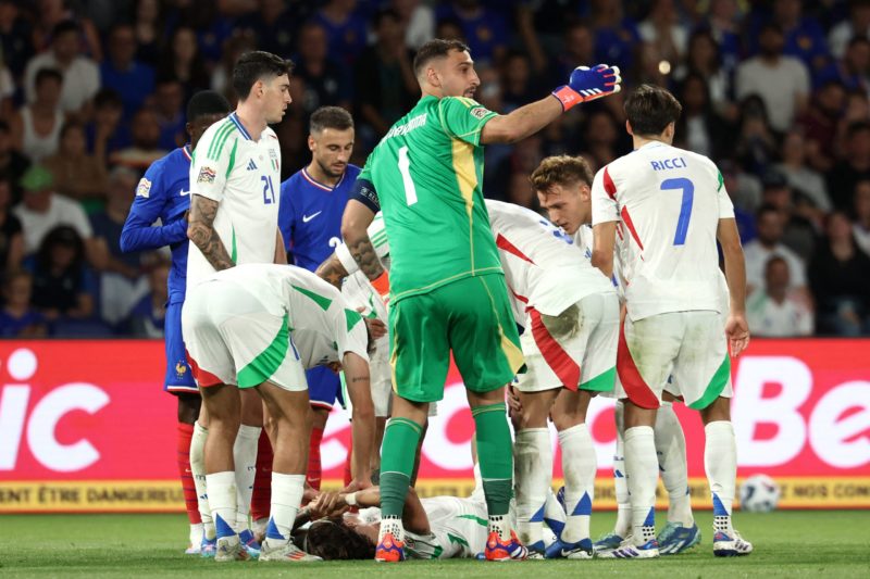 Italy's goalkeeper #01 Gianluigi Donnarumma gestures as Italy's defender #05 Riccardo Calafiori lies on the football pitch during the UEFA Nations League Group A2 football match between France and Italy at the Parc des Princes in Paris on September 6, 2024. (Photo by FRANCK FIFE/AFP via Getty Images)