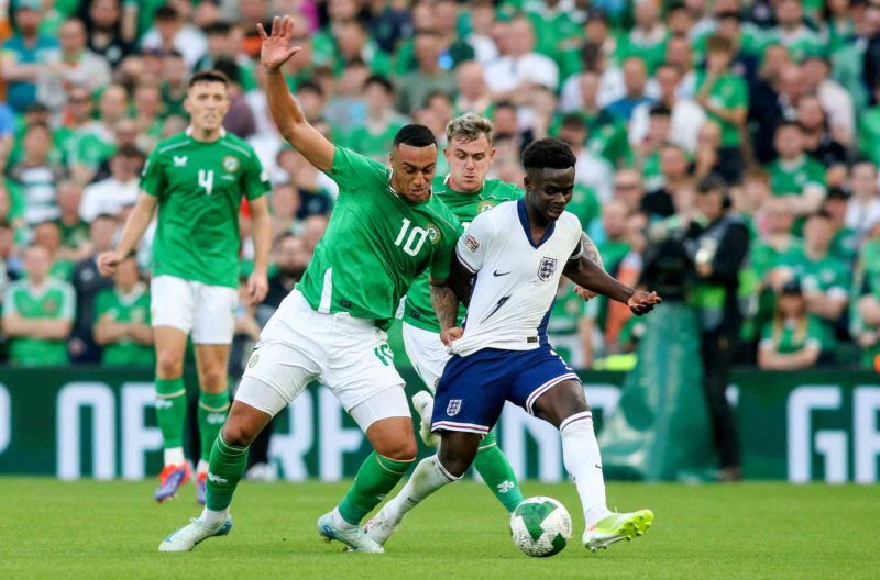 Ireland's forward. #10 Adam Idah vies for the ball with England's midfielder #07 Bukayo Saka during the UEFA Nations League, League B, group 2, football match between Ireland and England at the Aviva Stadium, in Dublin, on September 7, 2024. (Photo by PAUL FAITH/AFP via Getty Images)