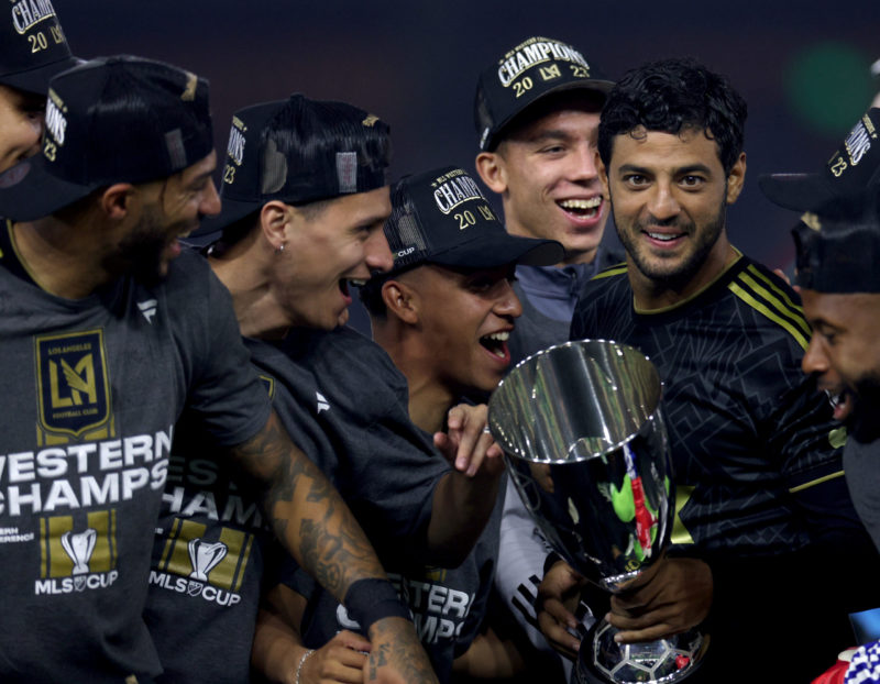 LOS ANGELES, CALIFORNIA - DECEMBER 02: Captain Carlos Vela #10 of Los Angeles FC makes his way to the front of the podium with the trophy after a 2-0 win over the Houston Dynamo in the Western Conference Final at BMO Stadium on December 02, 2023 in Los Angeles, California. (Photo by Harry How/Getty Images)