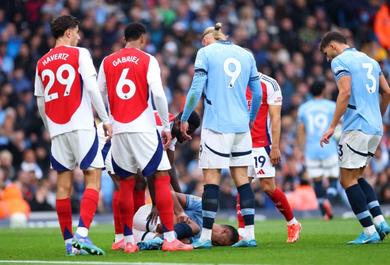 MANCHESTER, ENGLAND - SEPTEMBER 22: Rodri of Manchester City reacts with an injury during the Premier League match between Manchester City FC and Arsenal FC at Etihad Stadium on September 22, 2024 in Manchester, England. (Photo by Carl Recine/Getty Images)