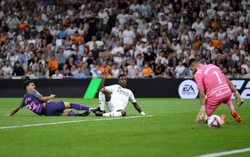 MADRID, SPAIN - SEPTEMBER 21: Joan Garcia of RCD Espanyol fails to stop Vinicius Junior of Real Madrid from scoring his team's third goal during the LaLiga match between Real Madrid CF and RCD Espanyol de Barcelona at Estadio Santiago Bernabeu on September 21, 2024 in Madrid, Spain. (Photo by David Ramos/Getty Images)