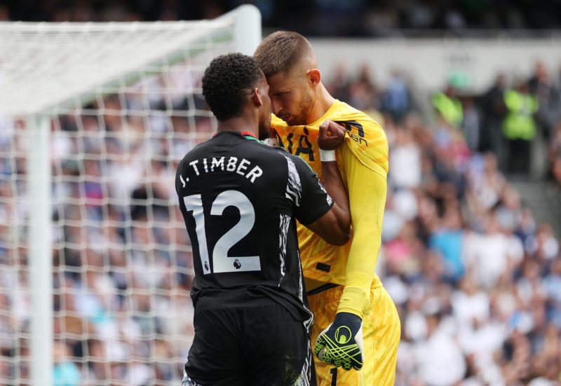 LONDON, ENGLAND - SEPTEMBER 15: Guglielmo Vicario of Tottenham Hotspur clashes with Jurrien Timber af Arsenal during the Premier League match between Tottenham Hotspur FC and Arsenal FC at Tottenham Hotspur Stadium on September 15, 2024 in London, England. (Photo by Alex Pantling/Getty Images)