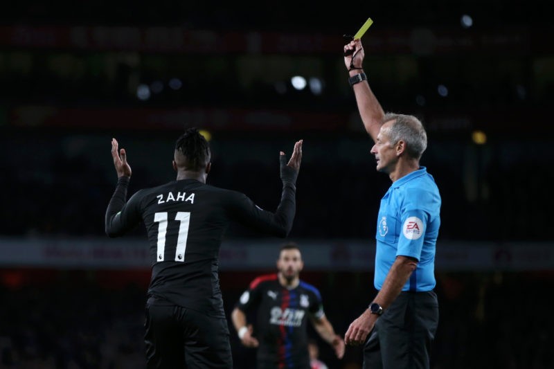 LONDON, ENGLAND - OCTOBER 27: Wilfried Zaha of Crystal Palace is shown a yellow card by referee Martin Atkinson but the card is later withdrawn following a VAR check during the Premier League match between Arsenal FC and Crystal Palace at Emirates Stadium on October 27, 2019 in London, United Kingdom. (Photo by Alex Morton/Getty Images)