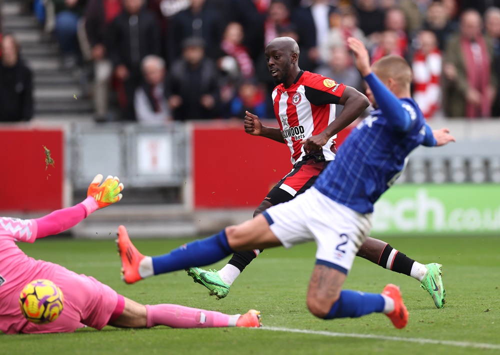 BRENTFORD, ENGLAND: Yoane Wissa of Brentford takes a shot before Harry Clarke of Ipswich Town (right) goes on to score an own goal and Brentford's second during the Premier League match between Brentford FC and Ipswich Town FC at Gtech Community Stadium on October 26, 2024. (Photo by Ryan Pierse/Getty Images)