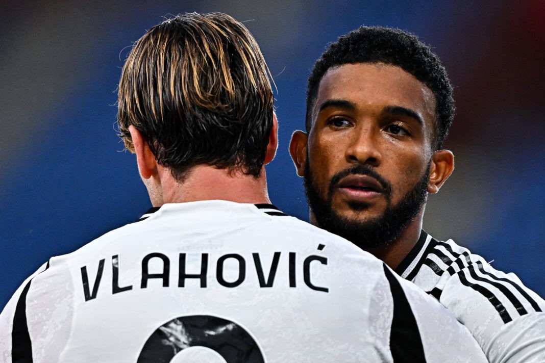 GENOA, ITALY - SEPTEMBER 28: Dusan Vlahovic of Juventus (left) celebrates with his team-mate Gleison Bremer after scoring a goal on a penalty kick during the Serie A match between Genoa and Juventus at Stadio Luigi Ferraris on September 28, 2024 in Genoa, Italy. (Photo by Simone Arveda/Getty Images)