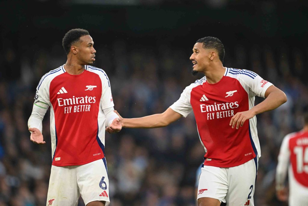 MANCHESTER, ENGLAND - SEPTEMBER 22: Gabriel and William Saliba of Arsenal speak during the Premier League match between Manchester City FC and Arsenal FC at Etihad Stadium on September 22, 2024 in Manchester, England. (Photo by Michael Regan/Getty Images)