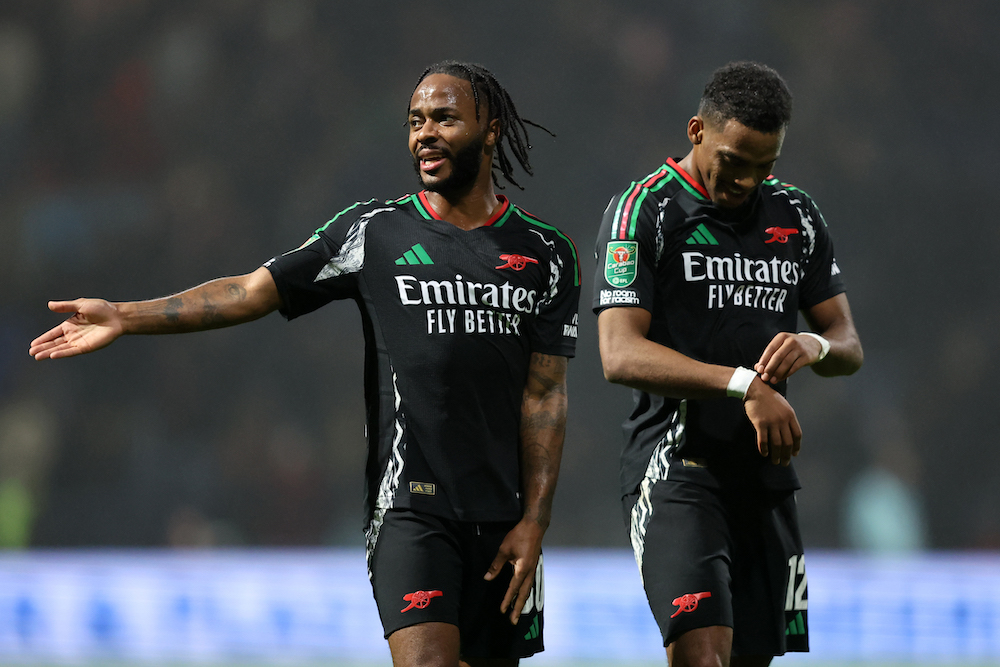 PRESTON, ENGLAND: Raheem Sterling speaks to teammate Jurrien Timber of Arsenal during the Carabao Cup Fourth Round match between Preston North End and Arsenal at Deepdale on October 30, 2024. (Photo by Matt McNulty/Getty Images)