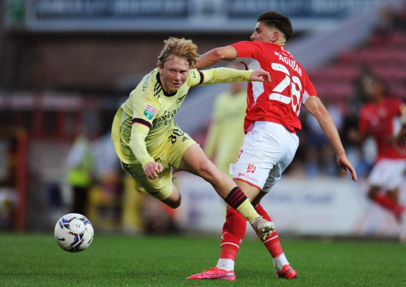 SWINDON, ENGLAND - SEPTEMBER 07: Jack Henry-Francis of Arsenal is tackled by Ricky Aguiar of Swindon Town during the Papa John's Trophy match between Swindon Town and Arsenal U21 at County Ground on September 07, 2021 in Swindon, England. (Photo by Alex Burstow/Getty Images)