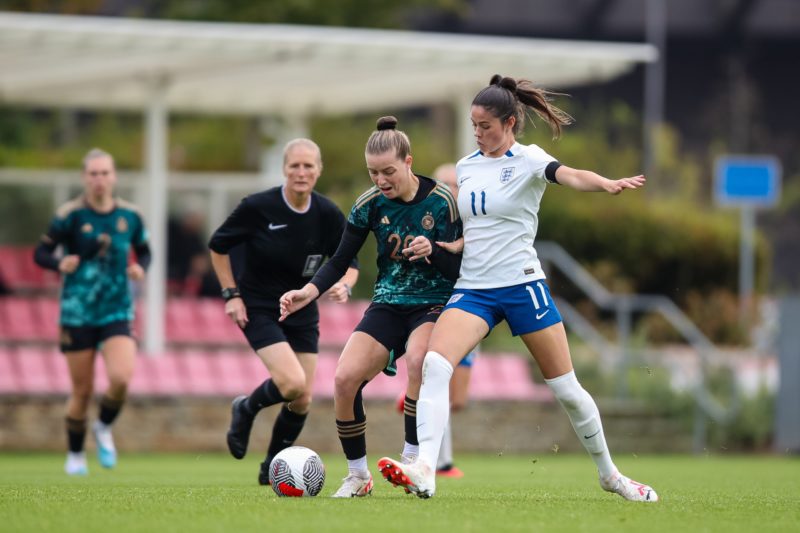 BURTON-UPON-TRENT, ENGLAND - SEPTEMBER 26: Alara Sehitler of Germany is challenged by Freya Godfrey of England during the international friendly match between England Women U19 and Germany Women U19 at St George's Park on September 26, 2023 in Burton-upon-Trent, England. (Photo by Jess Hornby/Getty Images for DFB)