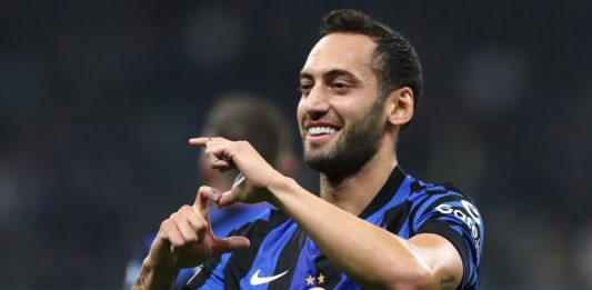 MILAN, ITALY: Hakan Calhanoglu of FC Internazionale celebrates scoring his team's first goal during the UEFA Champions League 2024/25 League Phase MD2 match between FC Internazionale Milano and FK Crvena Zvezda at Stadio San Siro on October 01, 2024. (Photo by Marco Luzzani/Getty Images)