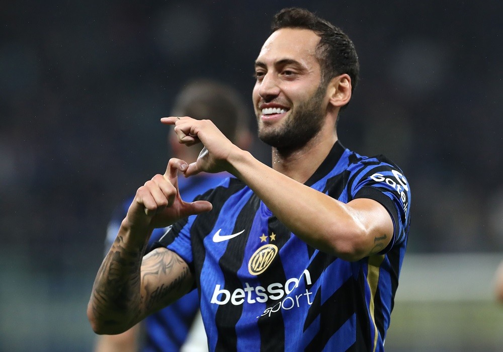 MILAN, ITALY: Hakan Calhanoglu of FC Internazionale celebrates scoring his team's first goal during the UEFA Champions League 2024/25 League Phase MD2 match between FC Internazionale Milano and FK Crvena Zvezda at Stadio San Siro on October 01, 2024. (Photo by Marco Luzzani/Getty Images)