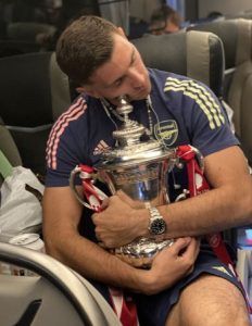 Emiliano Martinez, Arsenal goalkeeper, sleeps while hugging the FA Cup